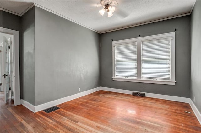 1401 E Mechanic Ave, Independence, MO 64050 - empty room with wood finished floors, ceiling fan, ornamental molding, and a textured ceiling