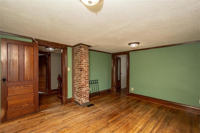 230 N 300th Rd, Overbrook, KS 66524 - spare room with hardwood / wood-style flooring, ornamental molding, and a textured ceiling
