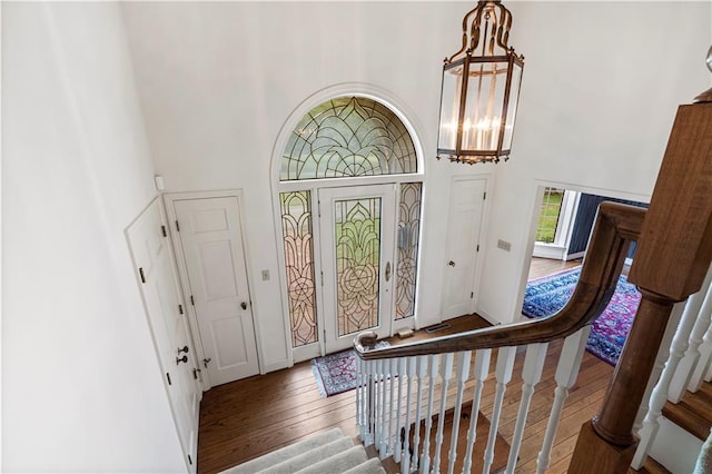 14908 E Pawhuska Rd, Nevada, MO 64772 - foyer entrance featuring a high ceiling, wood-type flooring, stairs, and a chandelier