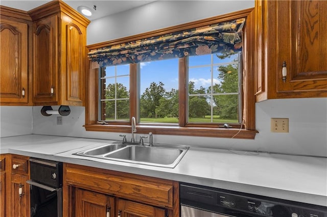 14908 E Pawhuska Rd, Nevada, MO 64772 - kitchen featuring dishwasher, light countertops, and brown cabinetry