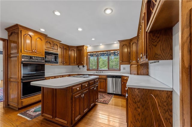 14908 E Pawhuska Rd, Nevada, MO 64772 - kitchen featuring black appliances, light countertops, light wood-style floors, and recessed lighting