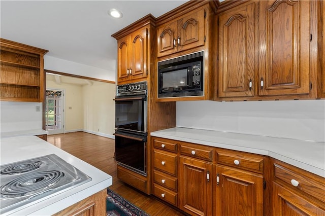 14908 E Pawhuska Rd, Nevada, MO 64772 - kitchen featuring black appliances, light countertops, dark wood-style floors, and recessed lighting