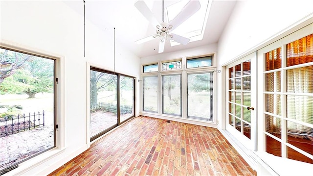 14908 E Pawhuska Rd, Nevada, MO 64772 - unfurnished sunroom featuring brick floors and a skylight