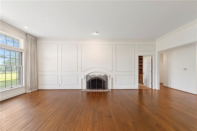 14908 E Pawhuska Rd, Nevada, MO 64772 - unfurnished living room featuring a fireplace with raised hearth, hardwood / wood-style flooring, and ornamental molding