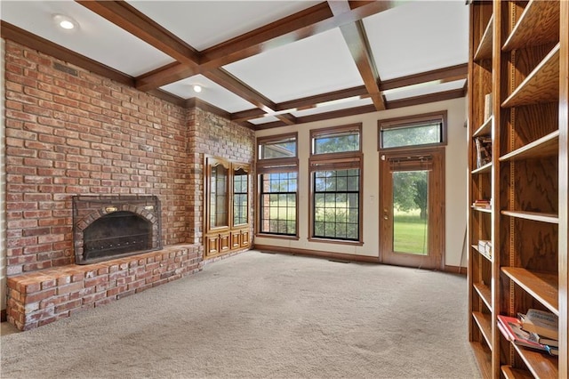 14908 E Pawhuska Rd, Nevada, MO 64772 - unfurnished living room featuring a fireplace, beam ceiling, carpet flooring, and coffered ceiling