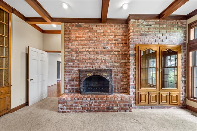 14908 E Pawhuska Rd, Nevada, MO 64772 - unfurnished living room with carpet flooring, beamed ceiling, a fireplace, and crown molding