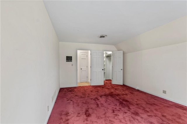 14908 E Pawhuska Rd, Nevada, MO 64772 - unfurnished bedroom featuring carpet floors, lofted ceiling, and a spacious closet