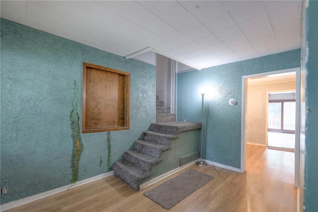 8519 Woodland Ave, Kansas City, MO 64131 - staircase with wood finished floors and a textured wall