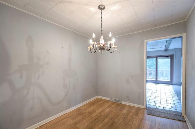 8519 Woodland Ave, Kansas City, MO 64131 - unfurnished room featuring a chandelier, ornamental molding, and wood finished floors