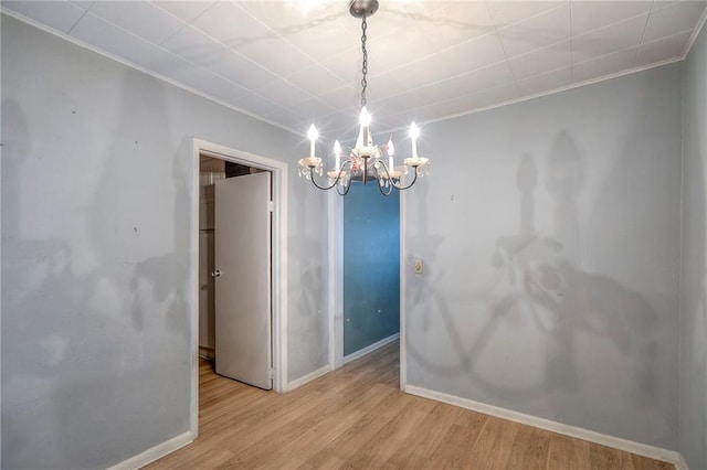 8519 Woodland Ave, Kansas City, MO 64131 - empty room with a chandelier, wood finished floors, and crown molding