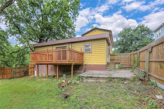8519 Woodland Ave, Kansas City, MO 64131 - rear view of house featuring a fenced backyard and a wooden deck