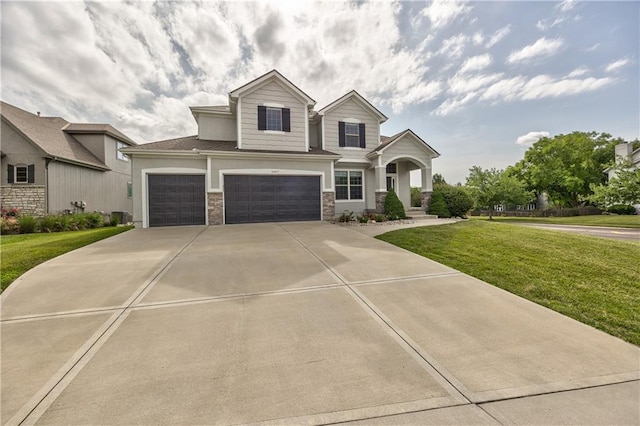 14017 Haskins St, Overland Park, KS 66221 - view of front of property with a front yard, a garage, driveway, and stone siding