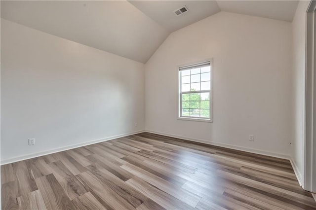 14017 Haskins St, Overland Park, KS 66221 - unfurnished room featuring vaulted ceiling and wood finished floors