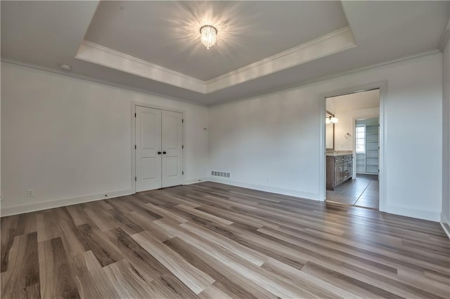 14017 Haskins St, Overland Park, KS 66221 - spare room with crown molding, a raised ceiling, and wood finished floors