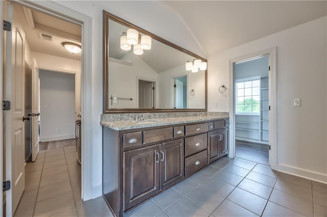 14017 Haskins St, Overland Park, KS 66221 - bathroom featuring lofted ceiling, tile patterned flooring, and double vanity