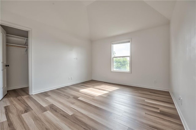 14017 Haskins St, Overland Park, KS 66221 - unfurnished bedroom with vaulted ceiling, light wood-style floors, and a closet