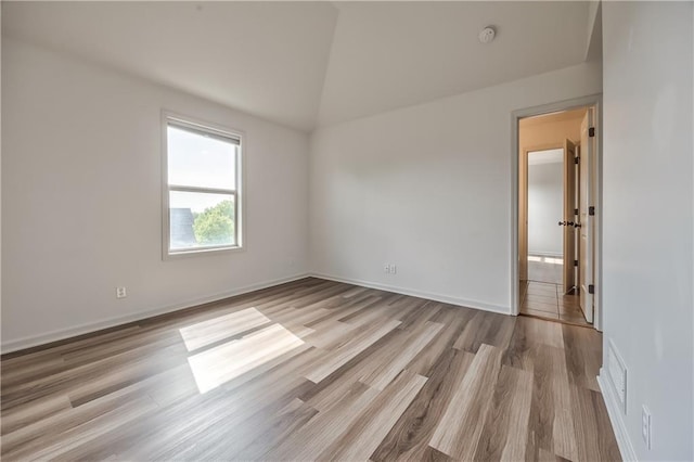 14017 Haskins St, Overland Park, KS 66221 - empty room with vaulted ceiling, wood finished floors, and a smoke detector