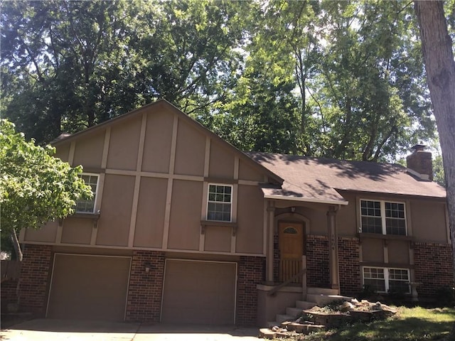 1404 SW 20th St, Blue Springs, MO 64015 - english style home with brick siding, a garage, a chimney, concrete driveway, and stucco siding