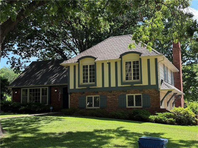 8117 Granada Rd, Prairie Village, KS 66208 - view of front of property with a chimney, a front yard, and brick siding