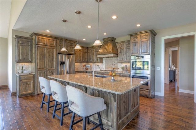 18670 W 248th St, Paola, KS 66071 - kitchen with appliances with stainless steel finishes, light stone countertops, backsplash, dark wood-type flooring, and recessed lighting
