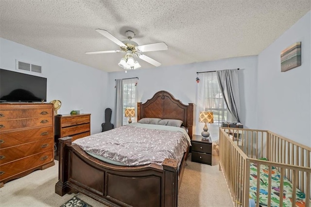 16304 W 126th St, Olathe, KS 66062 - bedroom with light carpet, multiple windows, a textured ceiling, and ceiling fan