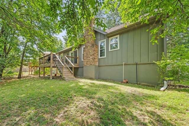 16304 W 126th St, Olathe, KS 66062 - rear view of house with board and batten siding, stairs, and a lawn