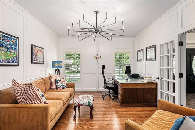 11401 Cedar St, Leawood, KS 66211 - home office with a decorative wall, light wood finished floors, healthy amount of natural light, a chandelier, and crown molding