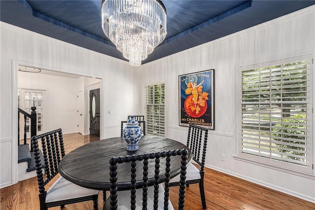 11401 Cedar St, Leawood, KS 66211 - dining area with a chandelier, wood finished floors, and a tray ceiling