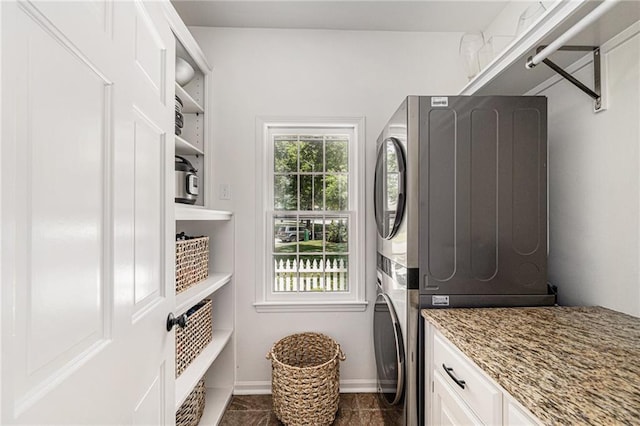 11401 Cedar St, Leawood, KS 66211 - washroom with stacked washer / drying machine and cabinet space