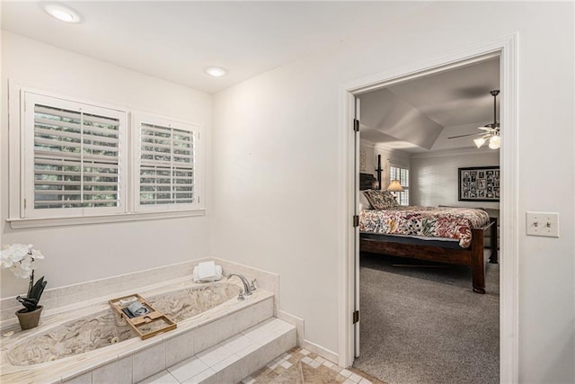 11401 Cedar St, Leawood, KS 66211 - ensuite bathroom featuring a garden tub, a tray ceiling, ceiling fan, and recessed lighting