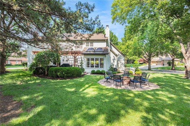 11401 Cedar St, Leawood, KS 66211 - rear view of property with a fire pit, a yard, and a chimney