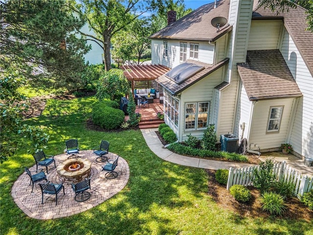 11401 Cedar St, Leawood, KS 66211 - rear view of property featuring a wooden deck, a pergola, a fire pit, a yard, and a chimney