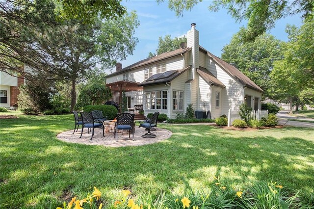 11401 Cedar St, Leawood, KS 66211 - rear view of house with a chimney, a patio area, and a yard