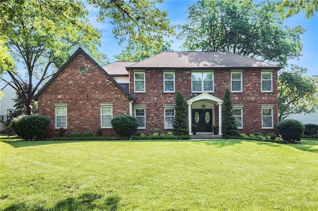 11401 Cedar St, Leawood, KS 66211 - colonial home featuring a front yard and brick siding