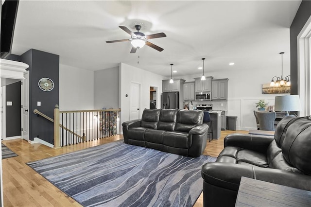 1013 SE Beatty Ct, Blue Springs, MO 64014 - living room with ceiling fan, light wood finished floors, a chandelier, and recessed lighting