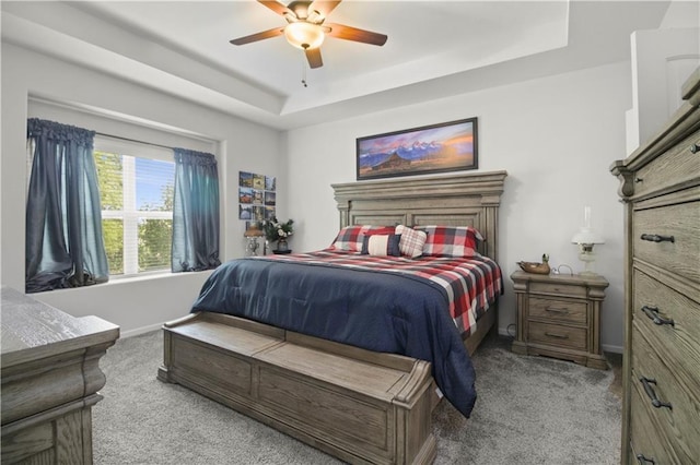 1013 SE Beatty Ct, Blue Springs, MO 64014 - bedroom with carpet floors, a tray ceiling, and a ceiling fan