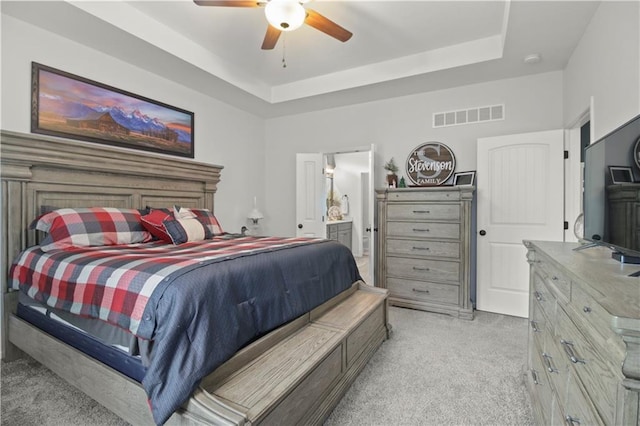 1013 SE Beatty Ct, Blue Springs, MO 64014 - bedroom with light colored carpet, a raised ceiling, ensuite bathroom, and ceiling fan