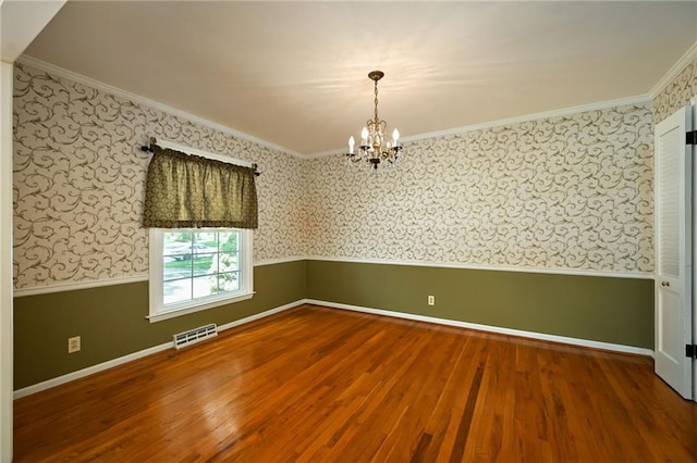 4411 W 89th St, Prairie Village, KS 66207 - unfurnished room with wallpapered walls, wood finished floors, ornamental molding, a chandelier, and wainscoting