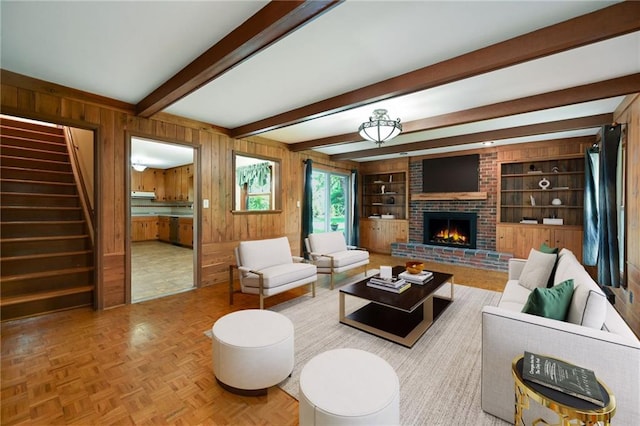 4411 W 89th St, Prairie Village, KS 66207 - living room featuring wood walls, a brick fireplace, beamed ceiling, stairs, and built in features