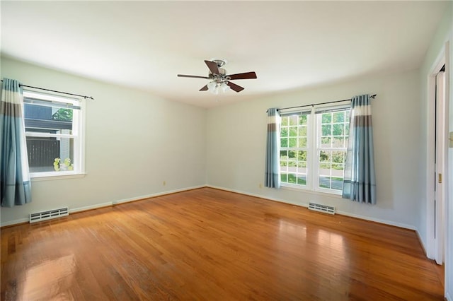 4411 W 89th St, Prairie Village, KS 66207 - unfurnished room featuring plenty of natural light, wood finished floors, and a ceiling fan