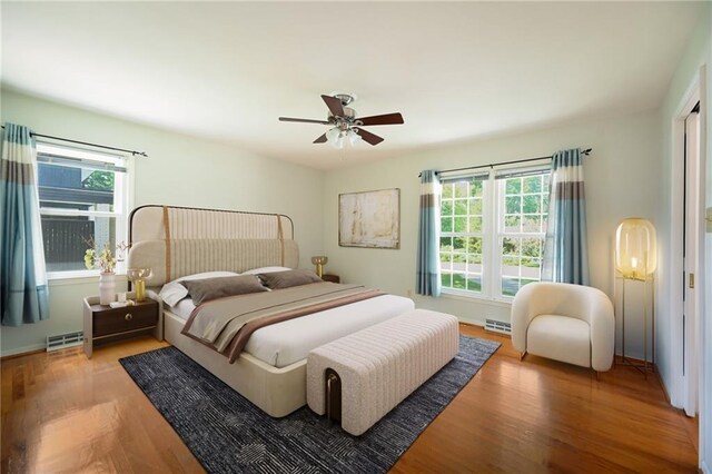 4411 W 89th St, Prairie Village, KS 66207 - bedroom with multiple windows, wood finished floors, and a ceiling fan