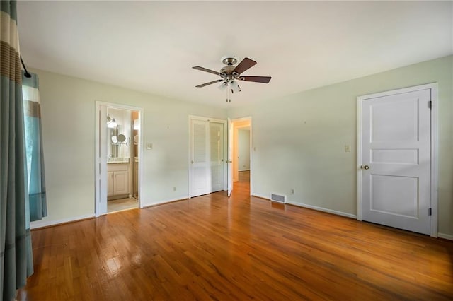 4411 W 89th St, Prairie Village, KS 66207 - unfurnished bedroom featuring wood finished floors, connected bathroom, and ceiling fan