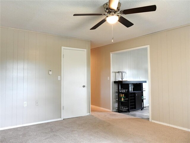 715 N Warren St, Warrensburg, MO 64093 - carpeted spare room featuring a ceiling fan and wood walls