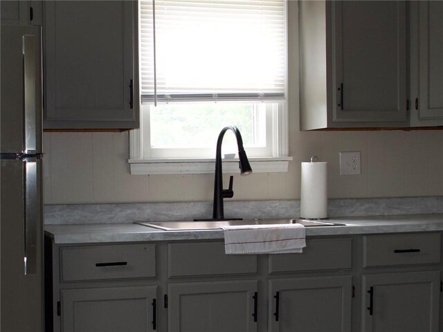 715 N Warren St, Warrensburg, MO 64093 - kitchen featuring freestanding refrigerator and light countertops