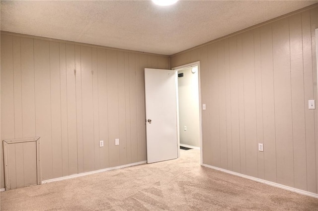 715 N Warren St, Warrensburg, MO 64093 - carpeted empty room with a textured ceiling and wooden walls