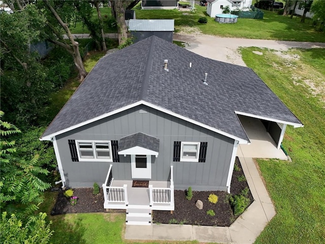 715 N Warren St, Warrensburg, MO 64093 - view of front of home with a shingled roof, a front yard, and board and batten siding