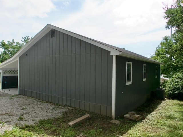 715 N Warren St, Warrensburg, MO 64093 - view of side of property with a central air condition unit and an attached carport