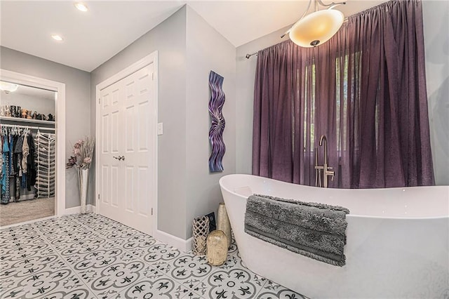 807 NW Bent Tree Dr, Lees Summit, MO 64081 - bathroom with a freestanding bath, recessed lighting, and a walk in closet