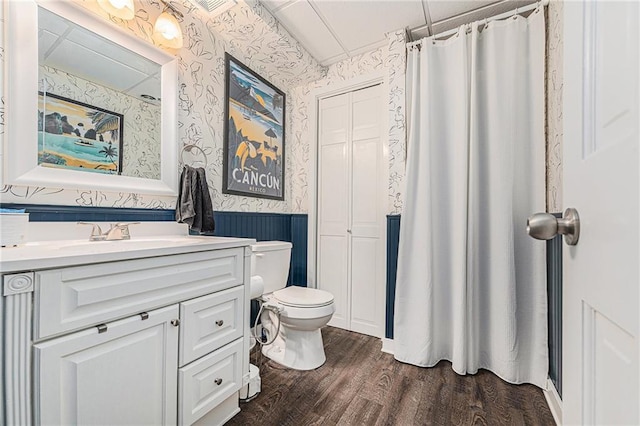 807 NW Bent Tree Dr, Lees Summit, MO 64081 - bathroom with wallpapered walls, a wainscoted wall, vanity, wood finished floors, and curtained shower