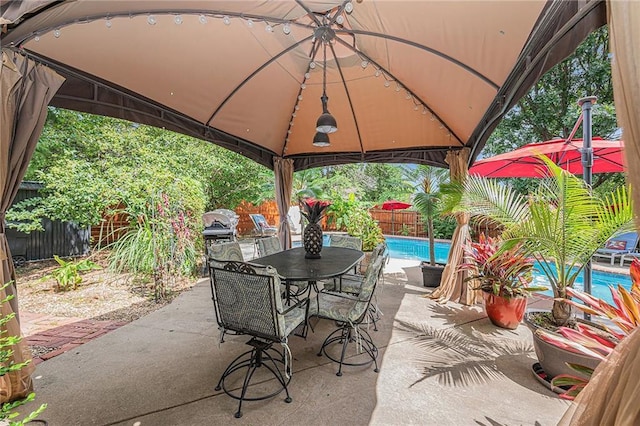 807 NW Bent Tree Dr, Lees Summit, MO 64081 - fenced backyard with a gazebo, outdoor dining area, and a patio area